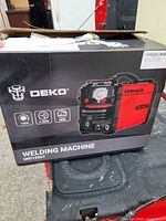 Retail box showing DEKO MIG135AT welding machine specifications