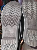 soles showing deep herringbone tread pattern and Dream Pairs logo