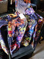 Front view of hoodie showing full graphic print, zipper, hood, hang tag