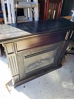 Front view of dark espresso freestanding electric fireplace mantel with insert