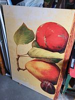 Front view of printed canvas showing fruit still life and wooden frame edge