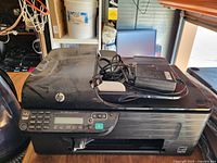Front-top view of HP Officejet 4500 printer with cords resting on scanner lid