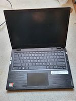 Laptop open showing keyboard, touchpad, screen and AMD A6 sticker
