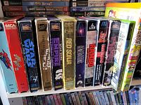 Row of VHS tapes on shelf, spines visible for title identification