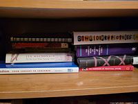 Shelf view showing all eight mixed-format books with visible titles and spines