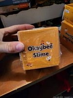 Front of sealed Okaybee Slime box with branding visible