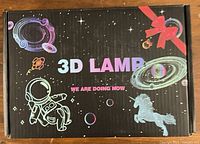 Closed retail box front labeled '3D Lamp' with space-themed graphics