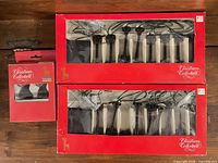 Front view of three red boxes showing lamp posts through window packaging