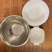 Top view showing colander, interior of ceramic bowl, CorningWare dish with lid
