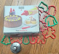 Closed Kuhn Rikon pastry decorating set box, metal Cut 'N Seal, holiday cookie cutters spread around