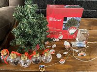 All items overview – tree with ornaments, Paw Patrol light string, boxed net lights, bulldog paperweight