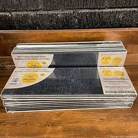 Stack of six shrink-wrapped LuxySplash textured glass tile packs