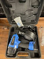 Nailer, safety glasses, parts bag inside branded case