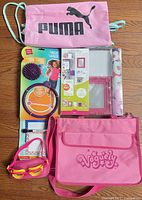 All items laid out: Puma bag, WallPops kit, Voguely bag, goggles, skip ball