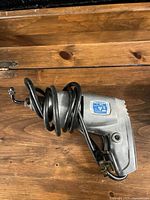 Left side view of Mor-Power corded drill showing body, trigger and cord