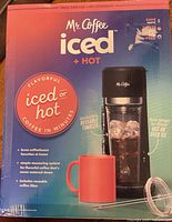 Front of boxed Mr. Coffee Iced + Hot brewer showing machine and included tumbler