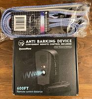 Front view showing leash in plastic wrap above boxed anti-barking device