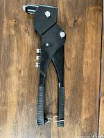 Full view of black steel rivet nut tool with rubber grips