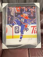 Front view showing signed Edmonton Oilers photographic print with mat and black frame