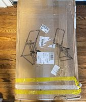 Full view of damaged cardboard box showing line drawing of assembled stepper/climber
