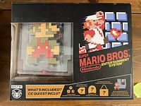 Front of sealed collector's box showing pixel Mario window and item list