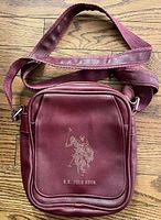 Front view showing embossed logo, overall shape, color, strap