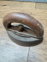 Top angled view showing full iron and inscription