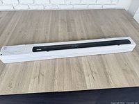 Full view of sealed retail box containing sound bar