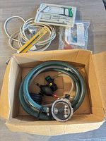 Group view showing green siphon hose, screwdriver set, extension cord, and packaged siphon kit