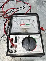 Front view of Sears 5205 analog multimeter with attached leads