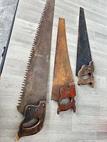 Overall view of three antique hand saws
