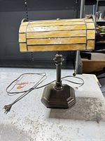 Front view of bronze base and amber stained glass shade with pull chain