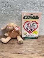 Camelia plush beside 1998 handbook