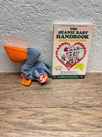 Scoop plush positioned beside The Beanie Baby Handbook