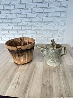 Wide shot of wooden bucket and galvanized watering can