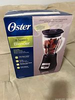 Front of boxed Oster 8-Speed Blender