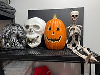 Group shot of skull, pumpkin, skeleton and animated ghost tombstone