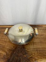 Covered serving dish assembled, showing lid with Bakelite knob and side handles