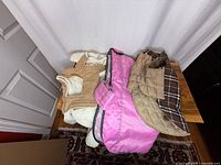 Three coats laid out showing colors and styles