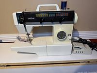 Full view of Brother VX561 sewing machine with foot pedal and cord