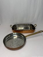 Both copper pans, rectangular and round, showing overall appearance