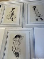 All three framed fashion sketch prints together