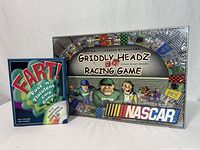 Sealed Griddly Headz Racing board game beside FART! card game box front