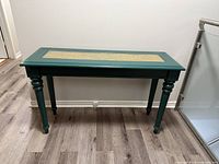 Full view of green console table against wall