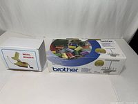 Wool winder box beside Brother thread holder box closed