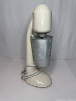 Front view of Hamilton Beach DrinkMaster mixer with metal cup attached