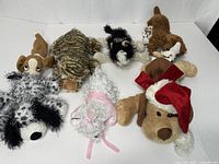 Group shot of seven assorted plush animal toys