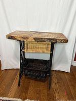 Front view of Singer treadle base table with both baskets in place