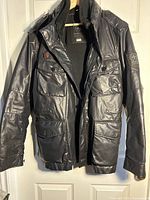 Front of black Strellson Swiss Cross Squad jacket hanging