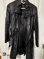 Full view interior of black leather coat hanging